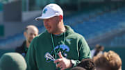 Tulane Green Wave football coach talks to his team after a practice session.