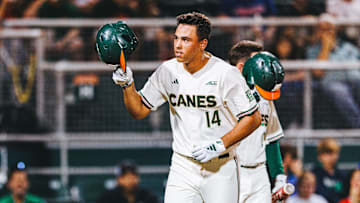 Miami Hurricanes third baseman Daniel Cuvet launches a ball out of the park for a home run against Notre Dame.