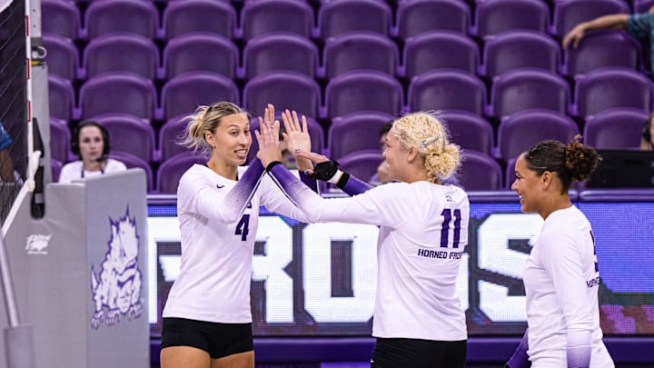 Becca Kelley, Sarah Sylvester and Jalyn Gibson celebrate a point scored in TCU Volleyball's win over Prairie View A&M on September 12, 2024. 