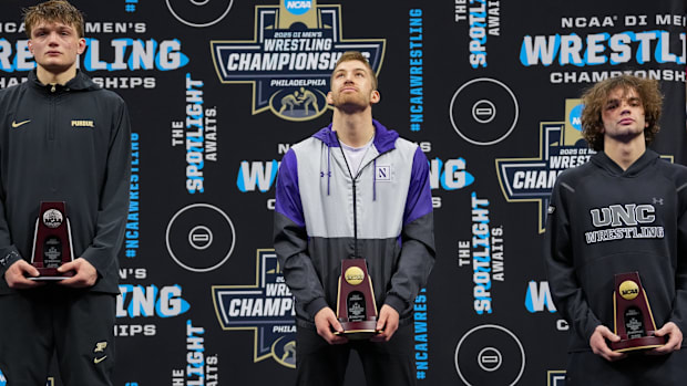 Northwestern wrestler Trevor Chumbley receives his trophy after placing fourth at the NCAA Wrestling Championships on 3/22/25