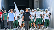 Tulane Green Wave football coach, Jon Sumrall, walks out of the tunnel with his team.