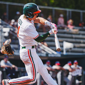 Miami's shortstop Jake Ogden smashing a homerun against UConn