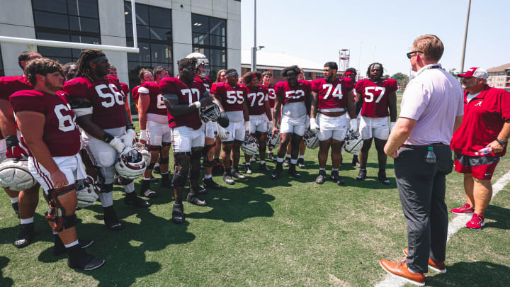 Former Alabama offensive lineman Barrett Jones speaks with OL coach Chris Kapilovic and the rest of the position group