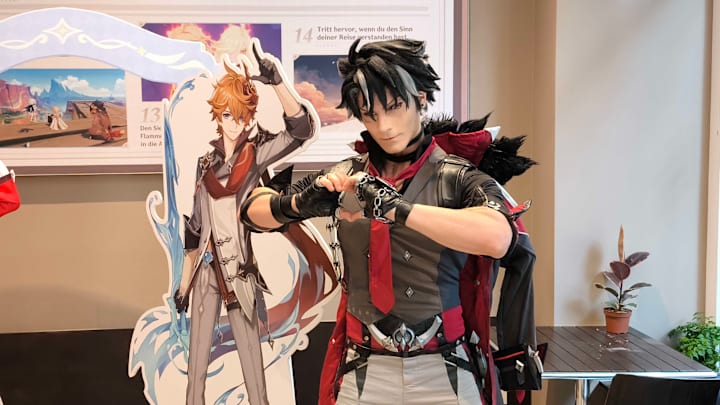 A Genshin Impact Wriothesley cosplayer poses for a photo.