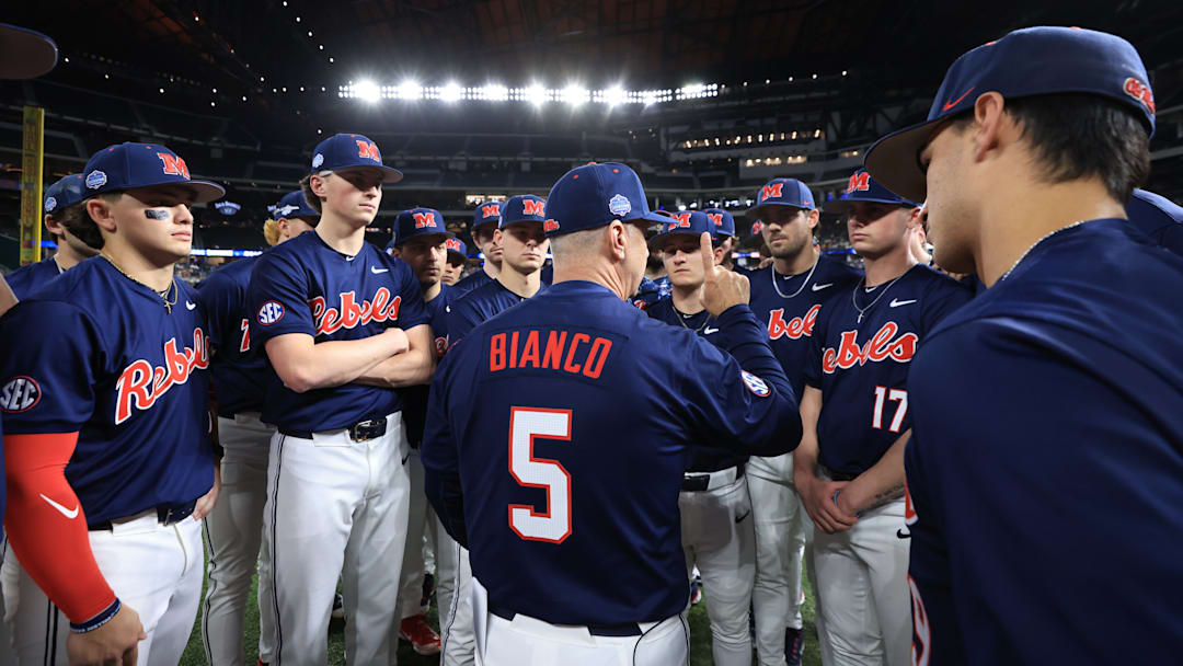 Ole Miss baseball coach Mike Bianco talks to players before the game against the Texas Longhorns at the Shriners Children's College Showdown in Arlington, Texas.