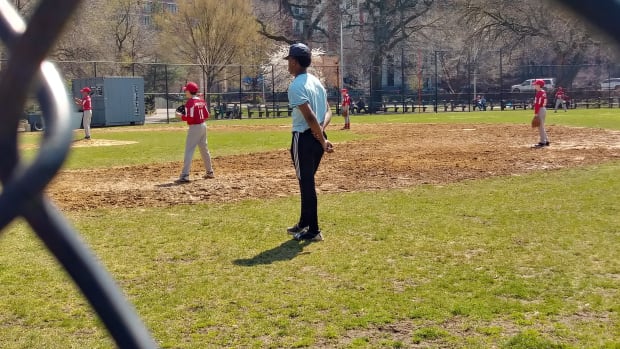 Rob Evans giving back to his old Harlem Little League as a teen umpire.