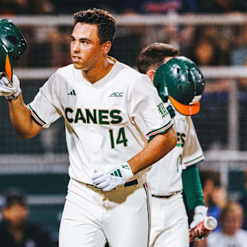 Miami Hurricanes third baseman Daniel Cuvet launches a ball out of the park for a home run against Notre Dame.