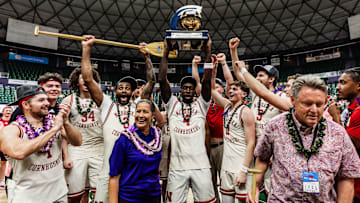 Nebraska basketball players pose with the Diamond Head Classic trophy after defeating Oregon State in the championship game.