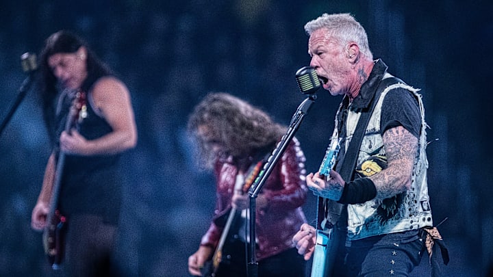 Metallica's James Hetfield performs next to Kirk Hammett and Robert Trujillo during the M72 World Tour at Ford Field in Detroit on Friday, Nov. 10, 2023