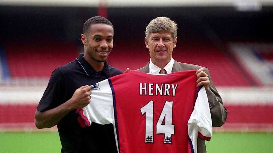 Thierry Henry (left) posing with his Arsenal shirt alongside Arsène Wenger.