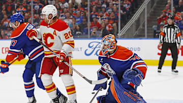 Calgary Flames forward Blake Coleman (20) deflects a shot wide of Edmonton Oilers goaltender Stuart Skinner (74)