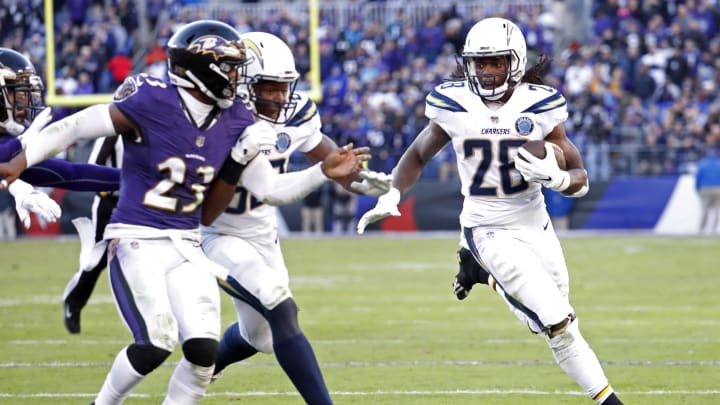 Jan 6, 2019; Baltimore, MD, USA; Los Angeles Chargers running back Melvin Gordon (28) carries the ball as Baltimore Ravens strong safety Tony Jefferson (23) chases in the third quarter in a AFC Wild Card playoff football game at M&T Bank Stadium. The Chargers won 23-17. Mandatory Credit: Geoff Burke-USA TODAY Sports