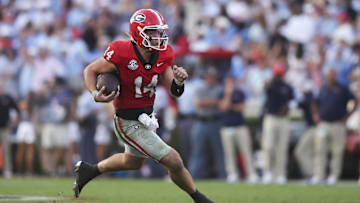 Georgia Bulldogs quarterback Gunner Stockton (14) runs the ball against the Mississippi Rebels during the second half of the game at Sanford Stadium. Credit: Brett Davis-Imagn Images