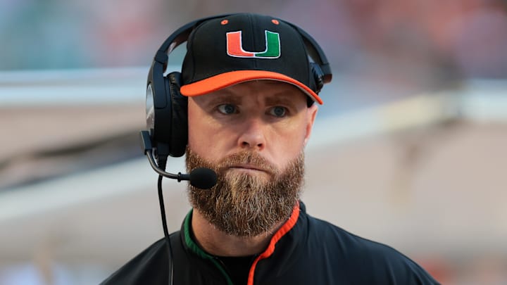 Nov 15, 2025; Miami Gardens, Florida, USA; against the Miami Hurricanes defensive coordinator Corey Hetherman watches from the sideline before the game against NC State Wolfpack at Hard Rock Stadium. Mandatory Credit: Sam Navarro-Imagn Images