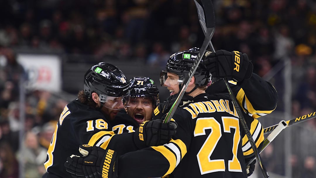 Mar 10, 2026; Boston, Massachusetts, USA; Boston Bruins center Pavel Zacha (18) left wing Viktor Arvidsson (71) defenseman Hampus Lindholm (27) celebrate a goal by defenseman Mason Lohrei (6) during the third period against the Los Angeles Kings at TD Garden. Mandatory Credit: Bob DeChiara-Imagn Images Mar 10, 2026; Boston, Massachusetts, USA; Boston Bruins center Pavel Zacha (18) left wing Viktor Arvidsson (71) defenseman Hampus Lindholm (27) celebrate a goal by defenseman Mason Lohrei (6) during the third period against the Los Angeles Kings at TD Garden. Mandatory Credit: Bob DeChiara-Imagn Images