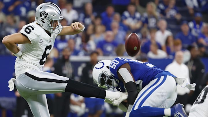 Oct 5, 2025; Indianapolis, Indiana, USA; Indianapolis Colts linebacker Segun Olubi (50) blocks a punt by Las Vegas Raiders punter AJ Cole (6) during the second quarter at Lucas Oil Stadium. Mandatory Credit: Trevor Ruszkowski-Imagn Images