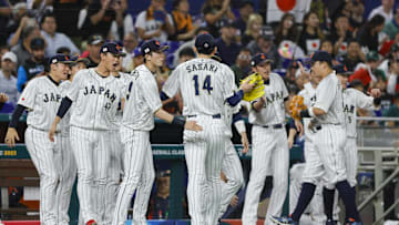 Mar 20, 2023; Miami, Florida, USA; Japan starting pitcher Roki Sasaki (14) celebrates with teammates after the first inning against Mexico at LoanDepot Park.