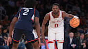 Indiana Hoosiers guard Xavier Johnson (0) dribbles in front of Connecticut Huskies guard Tristen Newton (2) during the second half at Madison Square Garden.