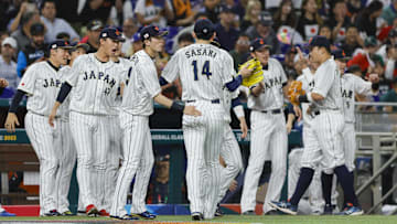 Mar 20, 2023; Miami, Florida, USA; Japan starting pitcher Roki Sasaki (14) celebrates with teammates after the first inning against Mexico at LoanDepot Park. Mandatory Credit: Sam Navarro-Imagn Images