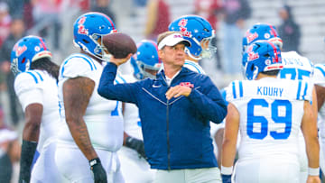 Oct 25, 2025; Norman, Oklahoma, USA;  Ole Miss Rebels head coach Lane Kiffin throws a football before the game against the Oklahoma Sooners at Gaylord Family-Oklahoma Memorial Stadium. Mandatory Credit: Kevin Jairaj-Imagn Images