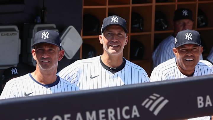 Aug 9, 2025; Bronx, New York, USA;  Former New York Yankees catcher Jorge Posada (l) watches from the dugout with former Yankees pitchers Andy Pettitte (c) and Mariano Rivera (r) during the Old Timer’s Day Ceremony at Yankee Stadium. Mandatory Credit: Wendell Cruz-Imagn Images