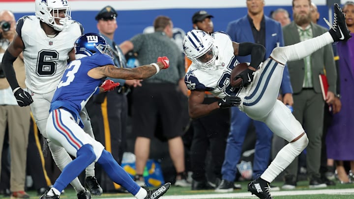 Sep 26, 2024; East Rutherford, New Jersey, USA; Dallas Cowboys cornerback Amani Oruwariye (27) intercepts a pass intended for New York Giants wide receiver Jalin Hyatt (13) in front of Cowboys safety Donovan Wilson (6) during the fourth quarter at MetLife Stadium. Mandatory Credit: Brad Penner-Imagn Images Sep 26, 2024; East Rutherford, New Jersey, USA; Dallas Cowboys cornerback Amani Oruwariye (27) intercepts a pass intended for New York Giants wide receiver Jalin Hyatt (13) in front of Cowboys safety Donovan Wilson (6) during the fourth quarter at MetLife Stadium. Mandatory Credit: Brad Penner-Imagn Images