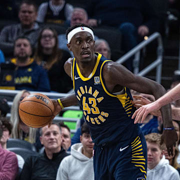 Feb 24, 2025; Indianapolis, Indiana, USA; Indiana Pacers forward Pascal Siakam (43) dribbles the ball while Denver Nuggets center Nikola Jokic (15) defends in the second half at Gainbridge Fieldhouse. Mandatory Credit: Trevor Ruszkowski-Imagn Images