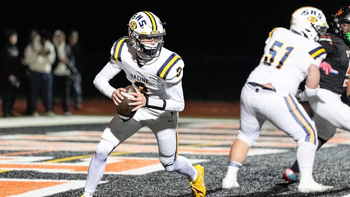 Saline quarterback Tommy Carr looks to pass against Belleville during the first half of district final at Belleville High School in Belleville on Friday, Nov. 8, 2024.