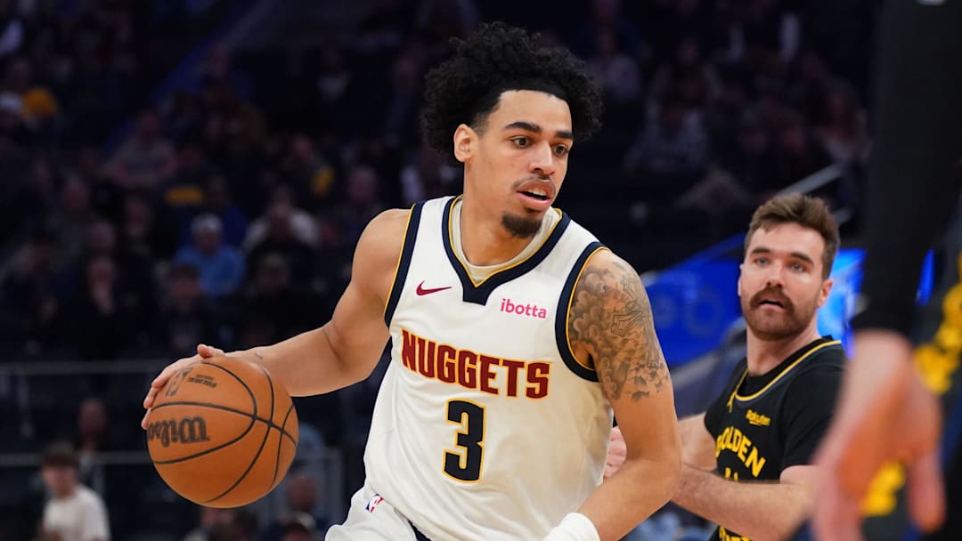 Feb 22, 2026; San Francisco, California, USA;  Denver Nuggets guard Julian Strawther (3) dribbles past Golden State Warriors guard Pat Spencer (61) in the third quarter at Chase Center.