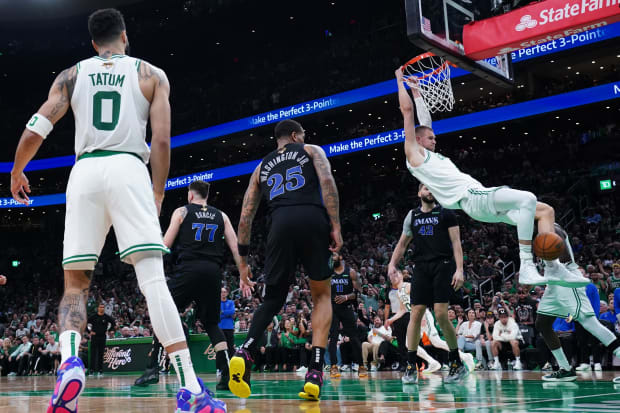 Celtics center Kristaps Porzingis (8) dunks against the Dallas Mavericks in the third quarter during game one of the finals.