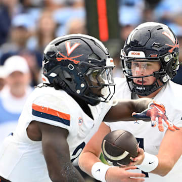 Oct 25, 2025; Chapel Hill, North Carolina, USA;  Virginia Cavaliers quarterback Chandler Morris (4) hands the ball off to wide receiver Andre Greene Jr. (2) in the third quarter at Kenan Stadium. Mandatory Credit: Bob Donnan-Imagn Images