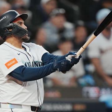 Oct 16, 2025; Seattle, Washington, USA; Seattle Mariners first baseman Josh Naylor (12) hits a solo home run against the Toronto Blue Jays in the second inning during game four of the ALCS round for the 2025 MLB playoffs at T-Mobile Park. Mandatory Credit: Stephen Brashear-Imagn Images