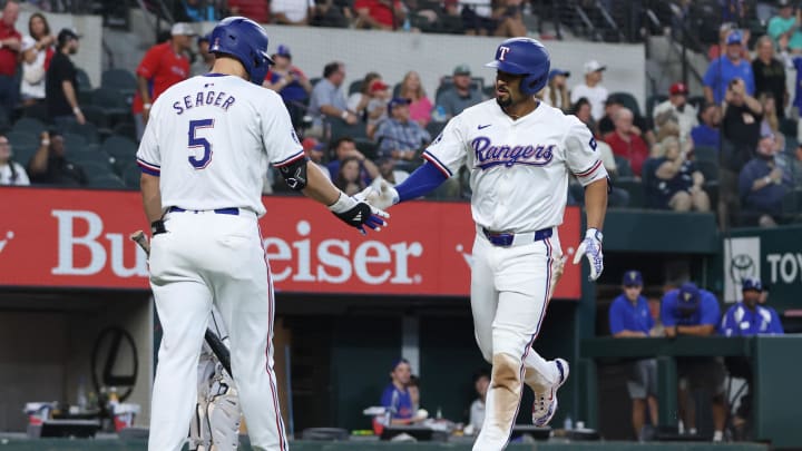 Jul 25, 2024; Arlington, Texas, USA; Texas Rangers second base Marcus Semien (2) celebrates with shortstop Corey Seager (5) after hitting a home run against the Chicago White Sox in the third inning at Globe Life Field. Mandatory Credit: Tim Heitman-USA TODAY Sports