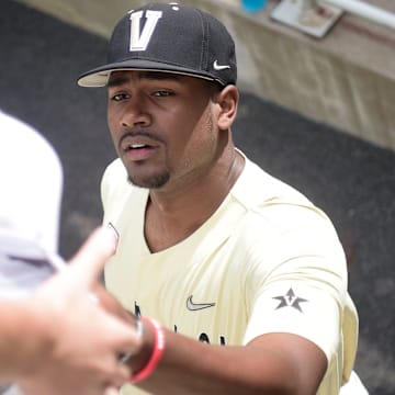 Vanderbilt right handed pitcher Kumar Rocker (80) signs autographs for young fans ahead of Game 1 of the College World Series finals at TD Ameritrade Park in Omaha, Neb. on Monday, June 28, 2021.