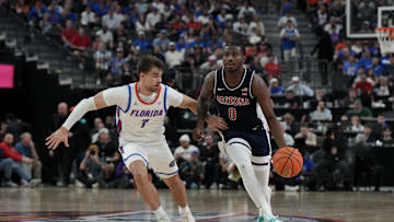 Nov 3, 2025; Las Vegas, NV, USA; Arizona Wildcats guard Jaden Bradley (0) dribbles against Florida Gators guard Urban Klavzar (7) during the second half of the Hall of Fame Series game at T-Mobile Arena. Mandatory Credit: Candice Ward-Imagn Images