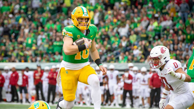 Oregon quarterback Bo Nix leaps into the end zone for a touchdown as the No. 9 Oregon Ducks host Washington State Saturday