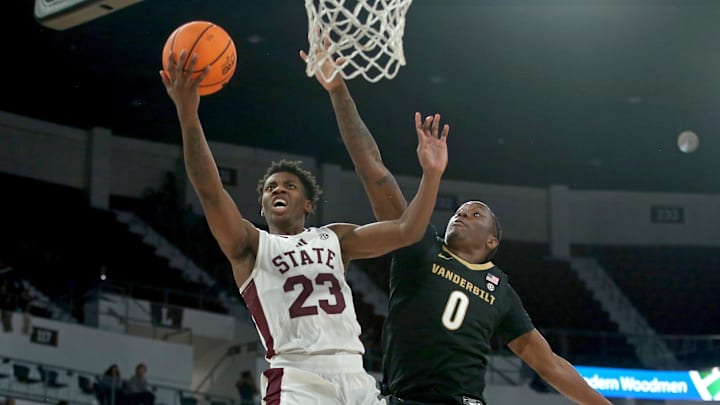 Jan 24, 2026; Starkville, Mississippi, USA; Mississippi State Bulldogs guard King Grace (23) drives to the basket as Vanderbilt Commodores guard Mike James (0) defends during the second half at Humphrey Coliseum. Mandatory Credit: Petre Thomas-Imagn Images