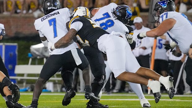 Buffalo Bulls quarterback C.J. Ogbonna (7) is sacked by Missouri Tigers defensive end Jahkai Lang (52) during the second half