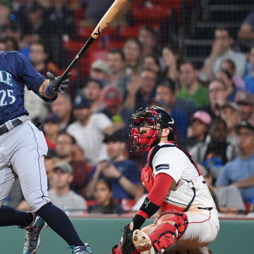 Seattle Mariners shortstop Dylan Moore hits an RBI single against the Boston Red Sox on Monday at Fenway Park. 