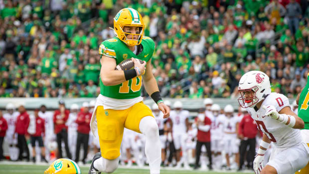 Oregon quarterback Bo Nix leaps into the end zone for a touchdown as the No. 9 Oregon Ducks host Washington State 