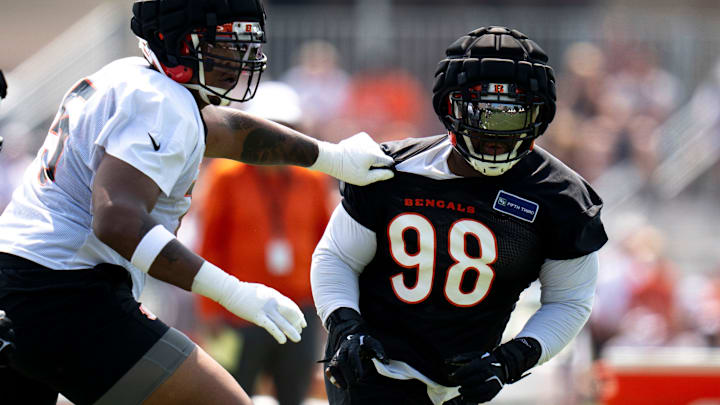 Cincinnati Bengals defensive tackle Sheldon Rankins (98) is blocked by Cincinnati Bengals offensive tackle Orlando Brown Jr. (75) during Cincinnati Bengals training camp in Cincinnati on Friday, July 26, 2024.