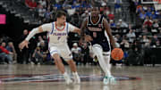 Nov 3, 2025; Las Vegas, NV, USA; Arizona Wildcats guard Jaden Bradley (0) dribbles against Florida Gators guard Urban Klavzar (7) during the second half of the Hall of Fame Series game at T-Mobile Arena. Mandatory Credit: Candice Ward-Imagn Images