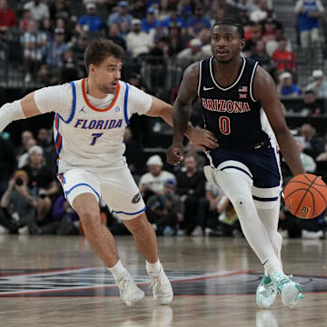 Nov 3, 2025; Las Vegas, NV, USA; Arizona Wildcats guard Jaden Bradley (0) dribbles against Florida Gators guard Urban Klavzar (7) during the second half of the Hall of Fame Series game at T-Mobile Arena. Mandatory Credit: Candice Ward-Imagn Images