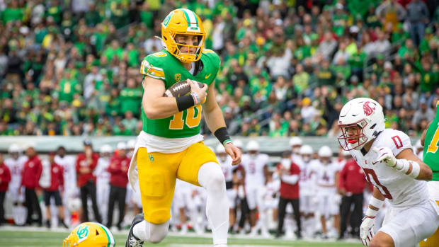 Oregon quarterback Bo Nix leaps into the end zone for a touchdown as the No. 9 Oregon Ducks host Washington State