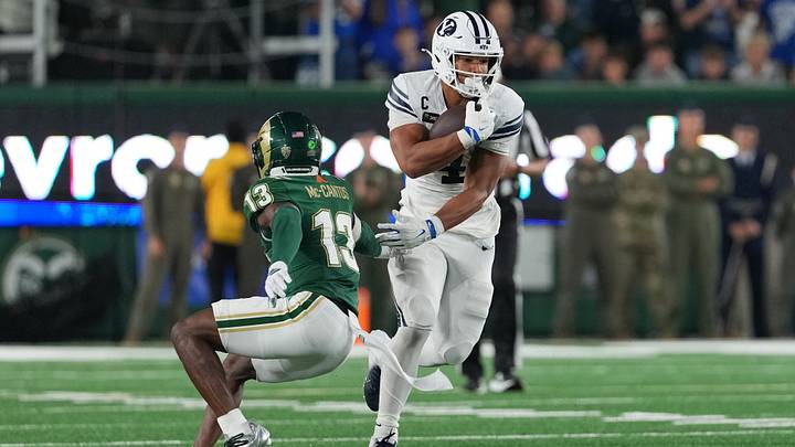 Sep 19, 2026; Fort Collins, Colorado, USA;  BYU Cougars running back Lj Martin (4) avoids a tackle by Colorado State Rams safety Elijah Mc-Cantos (13) at Sonny Lubick Field at Canvas Stadium.  Mandatory Credit: Andrew Rydland-Imagn Images