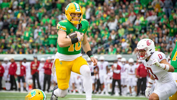 Oregon quarterback Bo Nix leaps into the end zone for a touchdown 