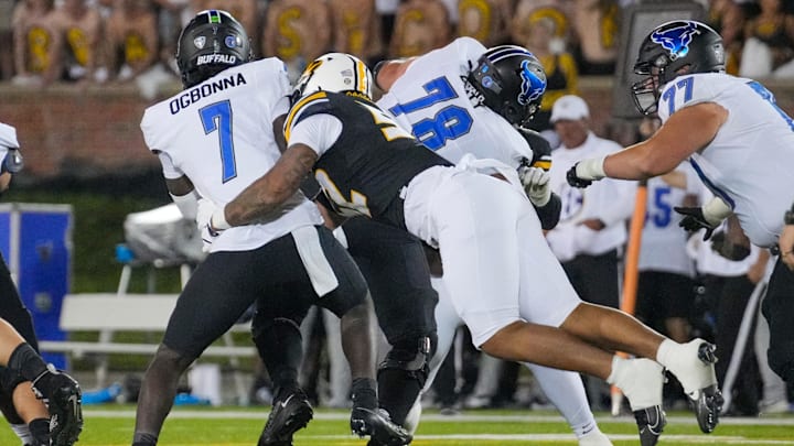 Sep 7, 2024; Columbia, Missouri, USA; Buffalo Bulls quarterback C.J. Ogbonna (7) is sacked by Missouri Tigers defensive end Jahkai Lang (52) during the second half at Faurot Field at Memorial Stadium. Mandatory Credit: Denny Medley-Imagn Images