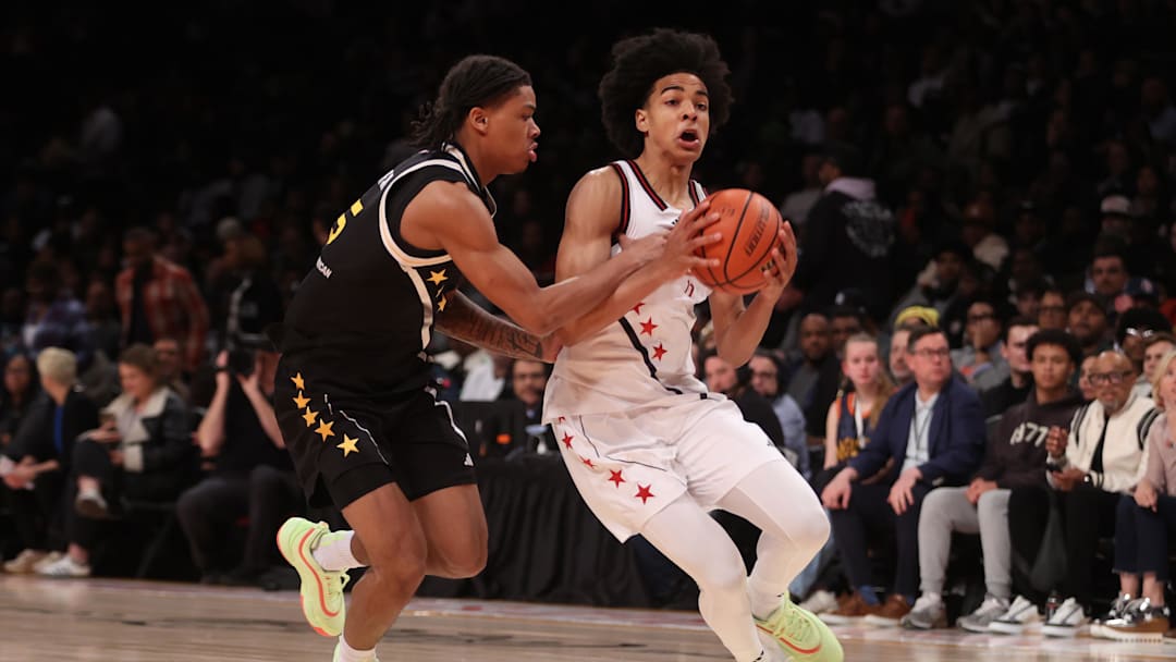 Apr 1, 2025; Brooklyn, NY, USA; McDonald's All American West guard Mikel Brown Jr. (11) dribbles the ball against McDonald's All American East guard Darius Acuff Jr. (5) during the first half of the game at Barclays Center. Mandatory Credit: Pamela Smith-Imagn Images