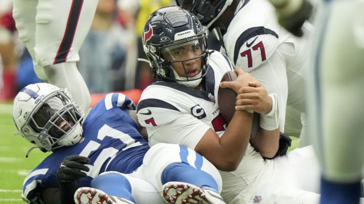 Sep 17, 2023; Houston, Texas, USA; Indianapolis Colts defensive end Kwity Paye (51) smiles after bringing down Houston Texans quarterback C.J. Stroud (7) at NRG Stadium. Mandatory Credit: Jenna Watson-USA TODAY Sports