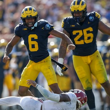 Dec 31, 2024; Tampa, FL, USA;  Alabama Crimson Tide quarterback Jalen Milroe (4) is sacked by Michigan Wolverines defensive back Brandyn Hillman (6) in the third quarter during the ReliaQuest Bowl at Raymond James Stadium. Mandatory Credit: Nathan Ray Seebeck-Imagn Images